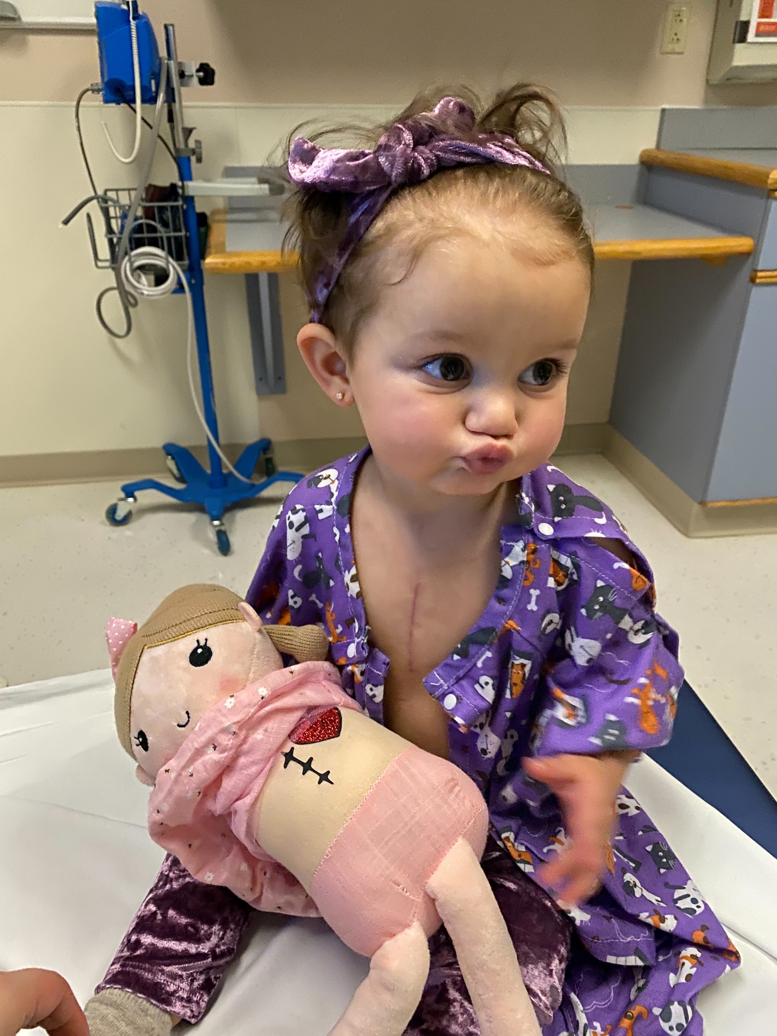 Vea with scar and baby doll (1).jpg